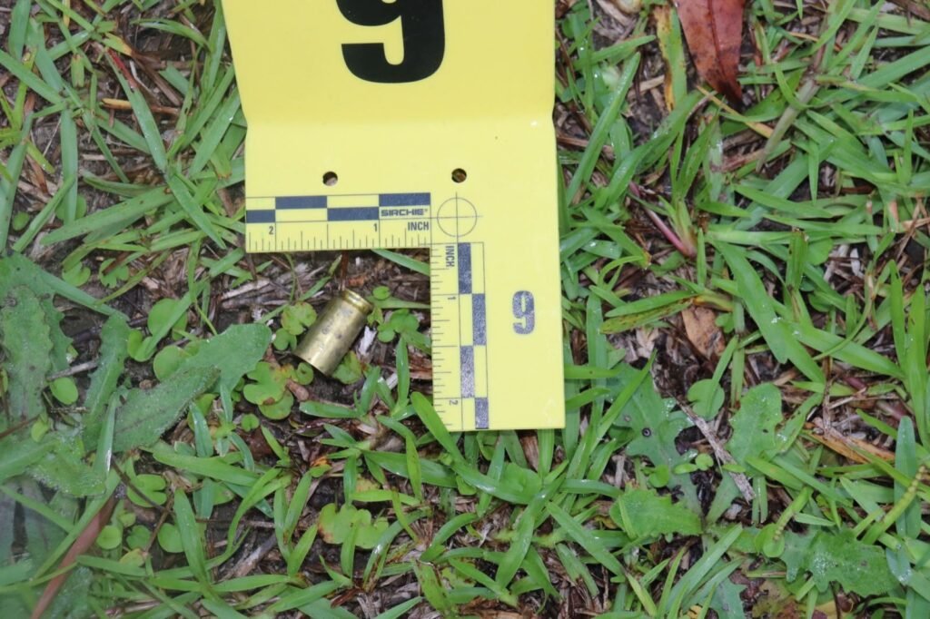 A spent .40 caliber casing beside evidence marker 9